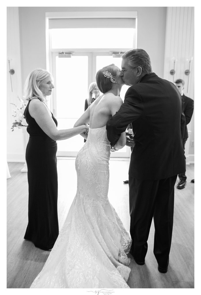 father gives bride away during wedding ceremony in Rhode Island by Sara Zarrella Photography