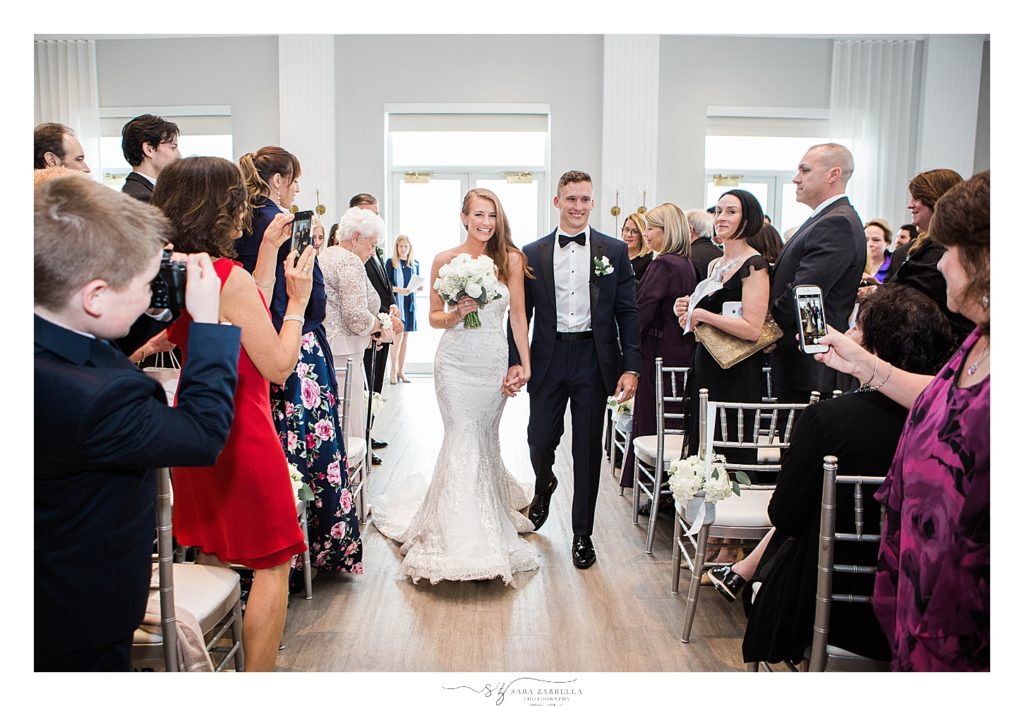 bride and groom recess up aisle photographed by RI wedding photographer Sara Zarrella Photography