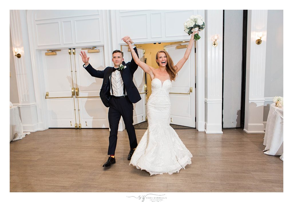 bride and groom enter wedding reception at Gurney's Newport Resort photographed by Sara Zarrella Photography