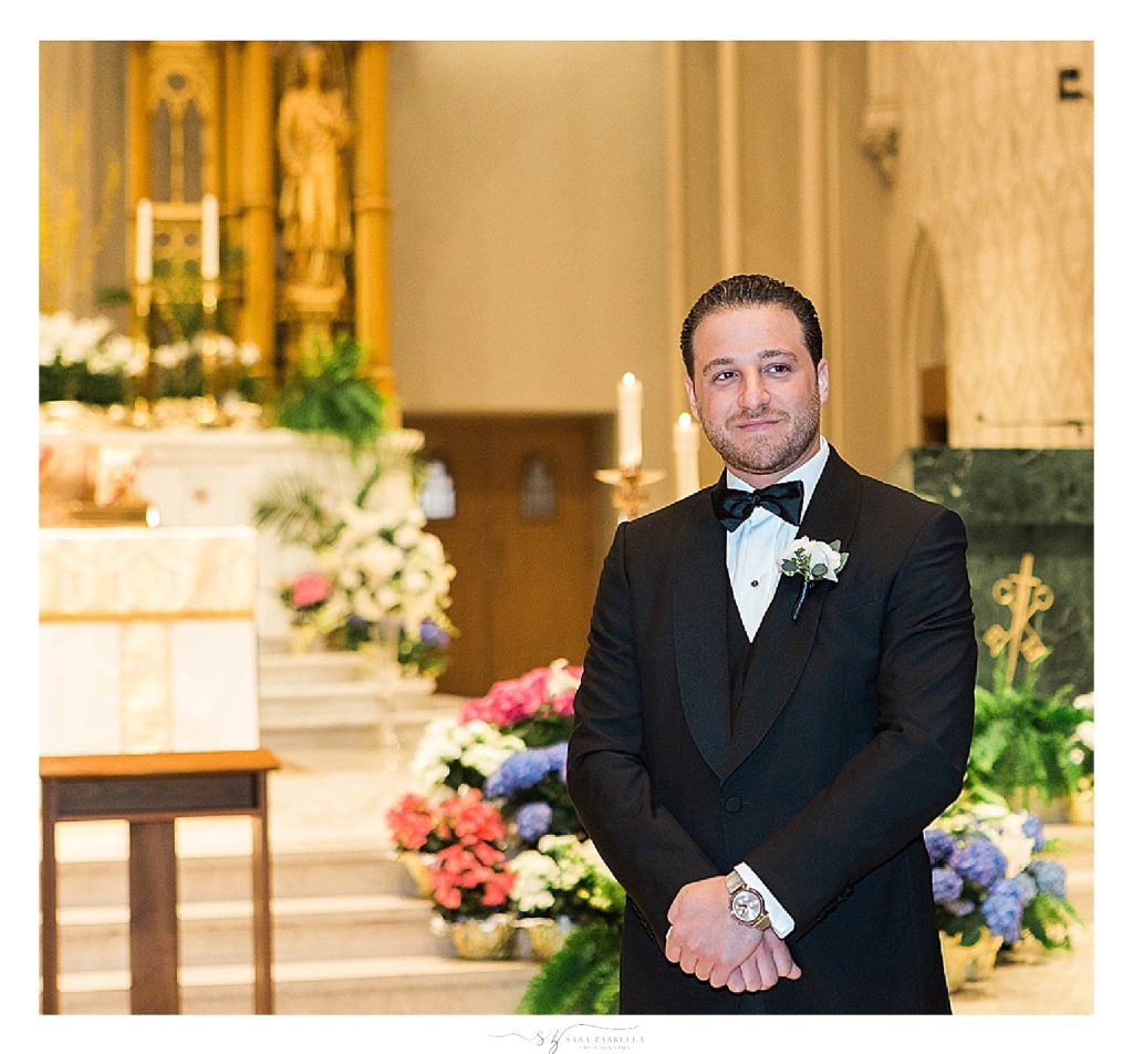 groom watches bride enter the Cathedral in Providence RI wedding by Sara Zarrella Photography