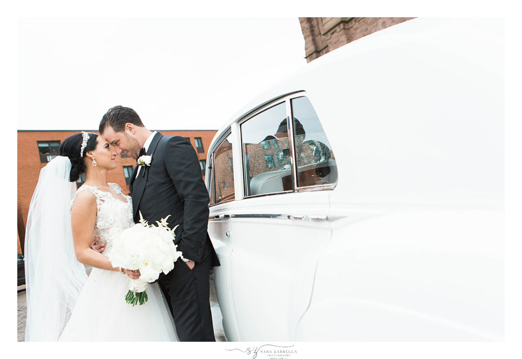 bride and groom pose outside classic car photographed by Rhode Island wedding photographer Sara Zarrella Photography
