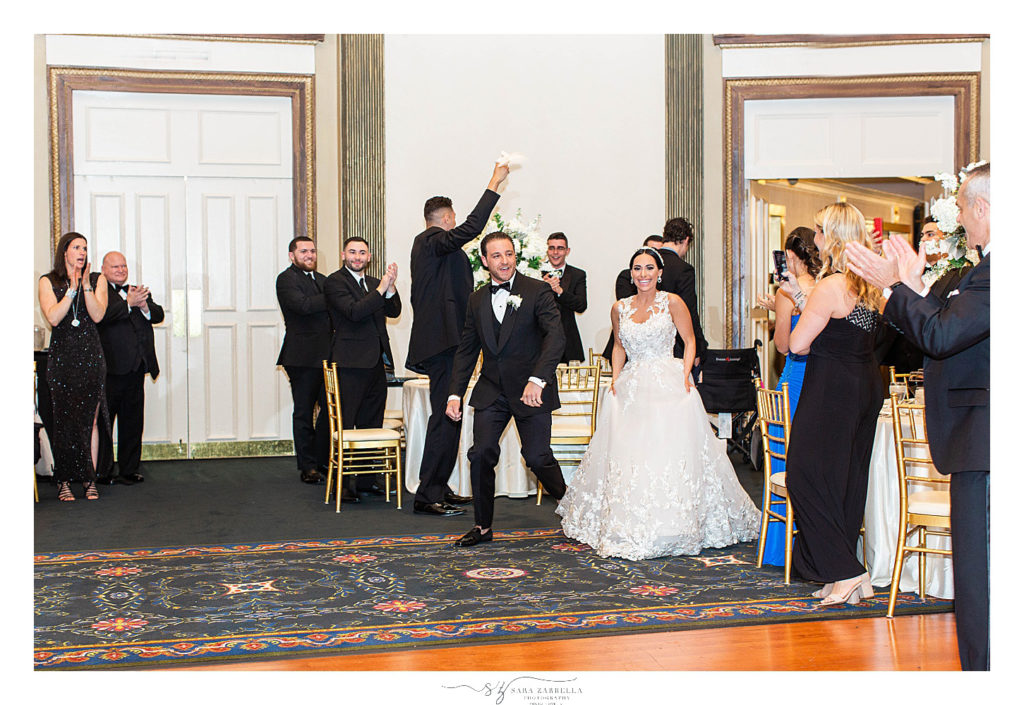 bride and groom enter reception at Graduate Providence photographed by Sara Zarrella Photography