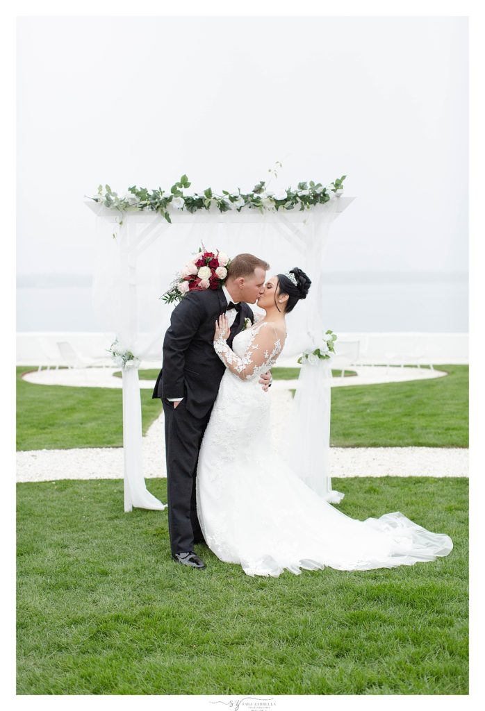 bride and groom kiss at alter photographed by wedding photographer Sara Zarrella Photography