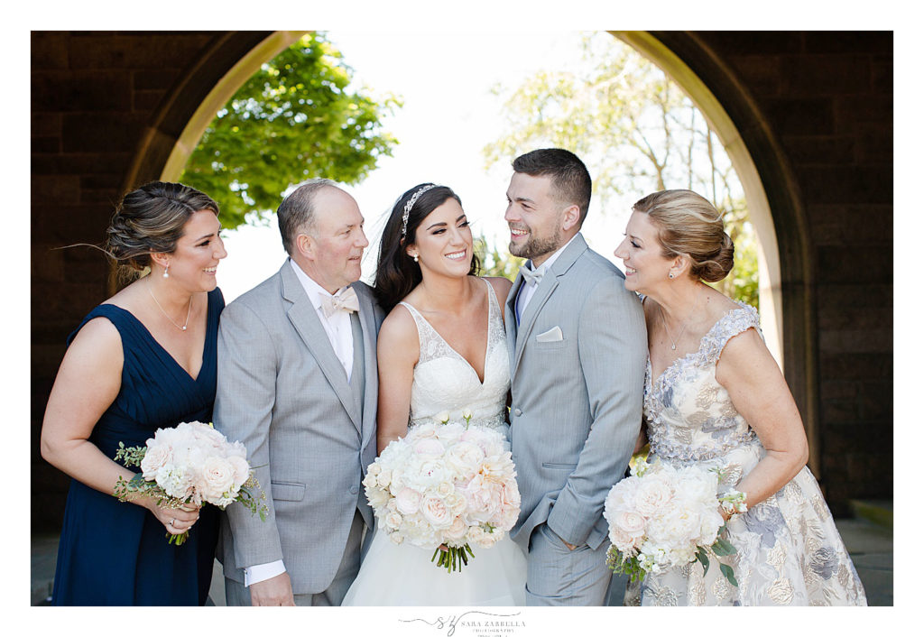 bride and groom pose with family in Rhode Island by Sara Zarrella Photography