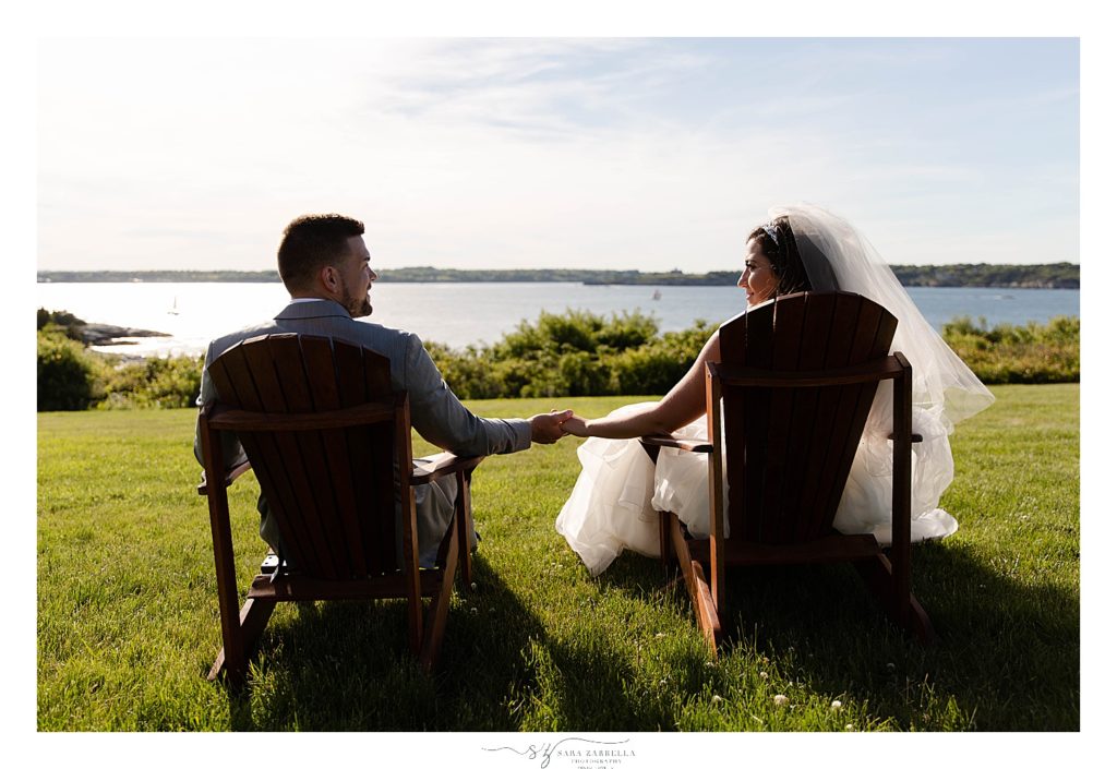 bride and groom relax looking at water photographed by Sara Zarrella Photography