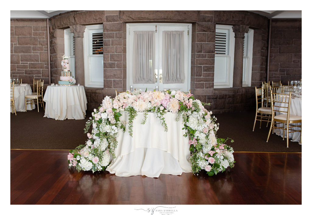 sweetheart table with draping florals photographed by Sara Zarrella Photography
