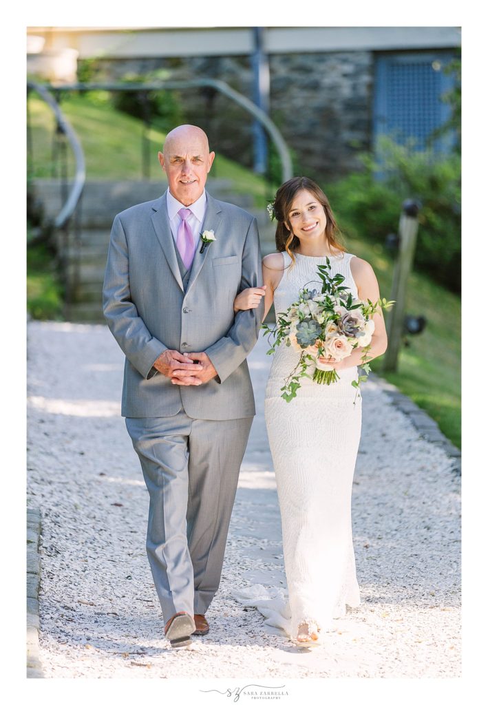 bride walks down aisle with father on wedding day at Squantum Association with Sara Zarrella Photography