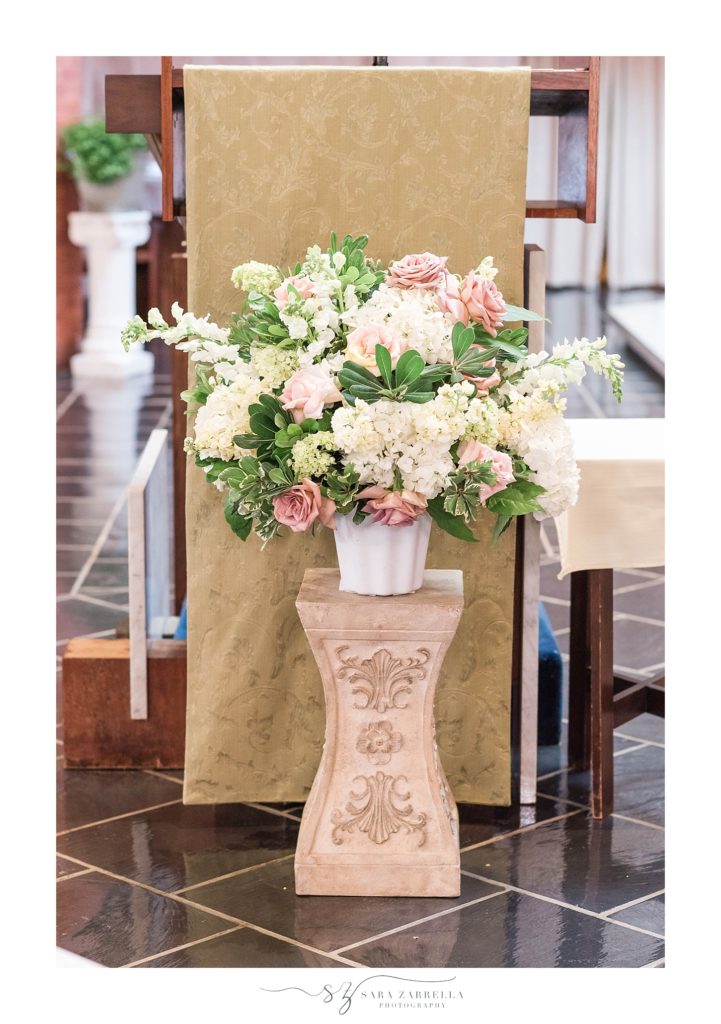 wedding florals line the ceremony photographed by Sara Zarrella Photography