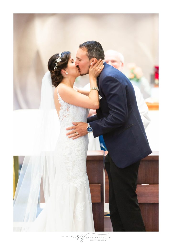 first kiss at Rhode Island wedding ceremony photographed by Sara Zarrella Photography