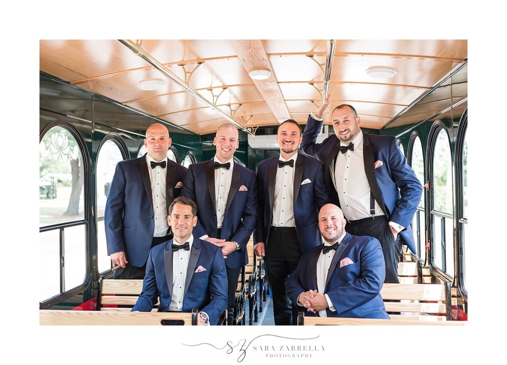 groomsmen on trolley photographed by Sara Zarrella Photography