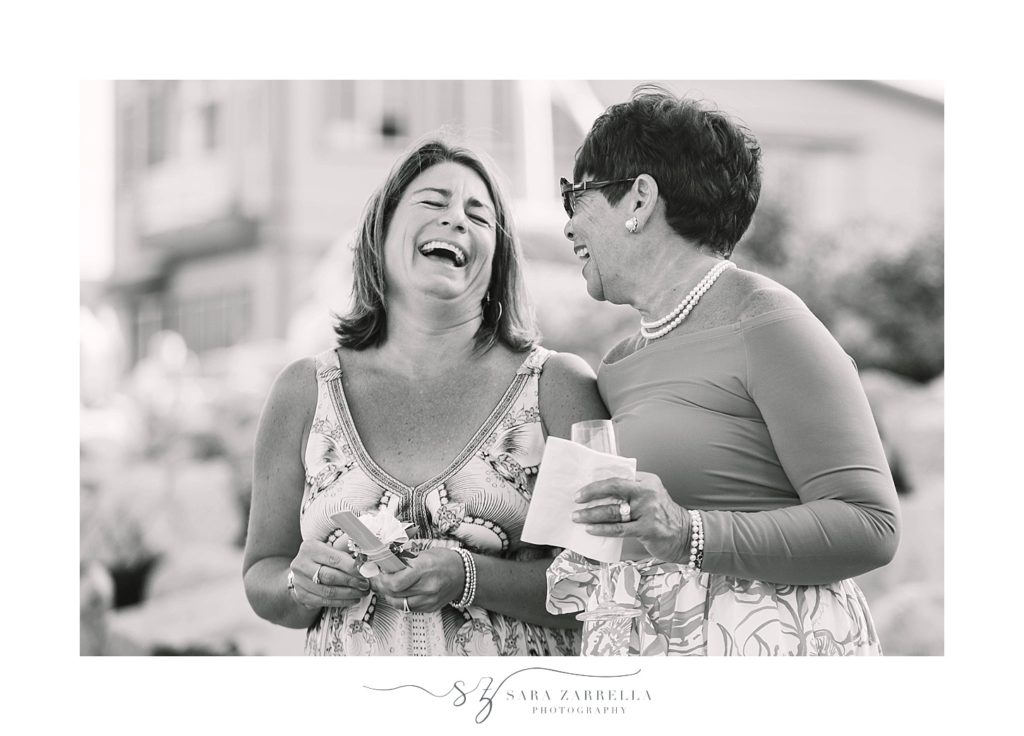 wedding guests laugh at Bonnet Shores wedding with Sara Zarrella Photography
