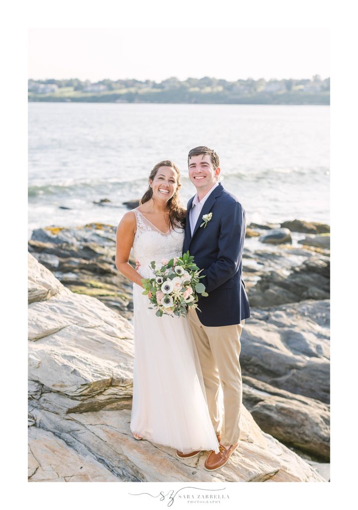 Sara Zarrella Photography photographs bride and groom along rocks in Rhode Island