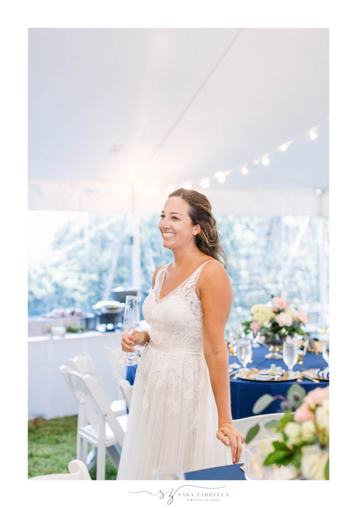 bride laughs during wedding toasts with Sara Zarrella Photography