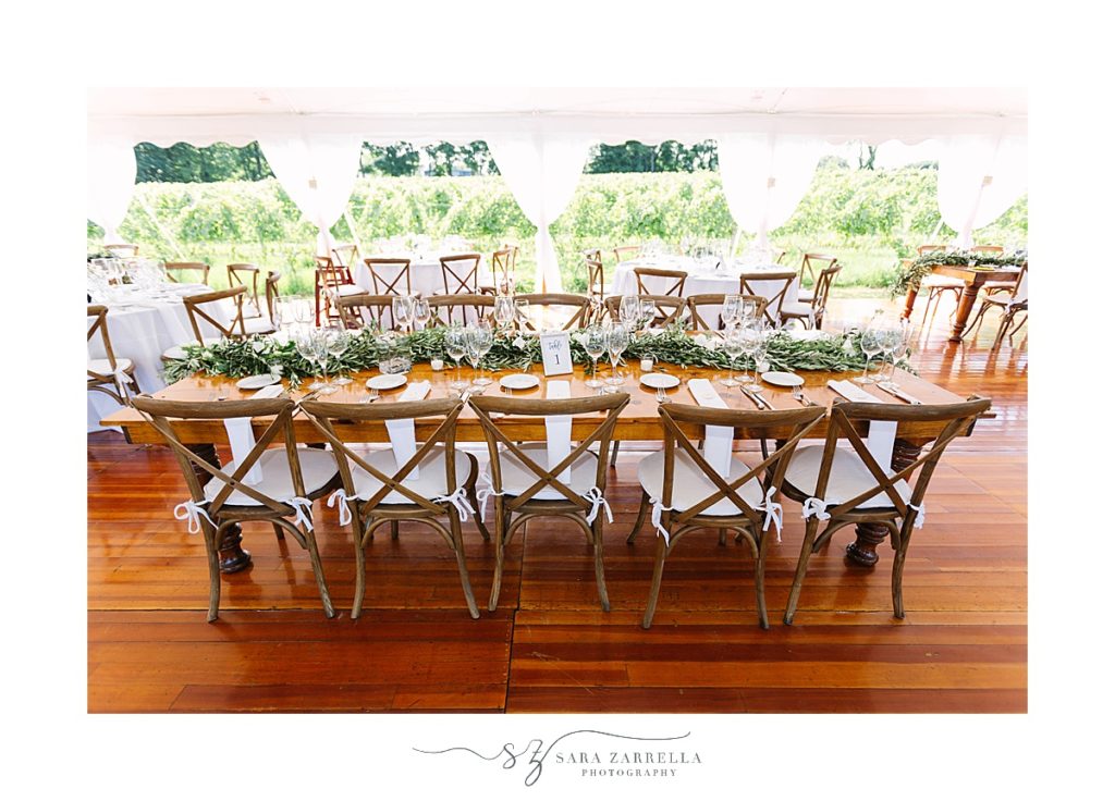 wood tables and greenery for reception decor photographed by Sara Zarrella Photography