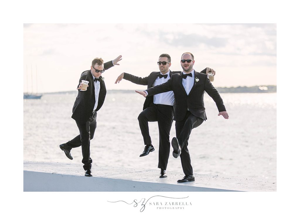 groomsmen playfully pose during Belle Mer wedding portraits with Sara Zarrella Photography
