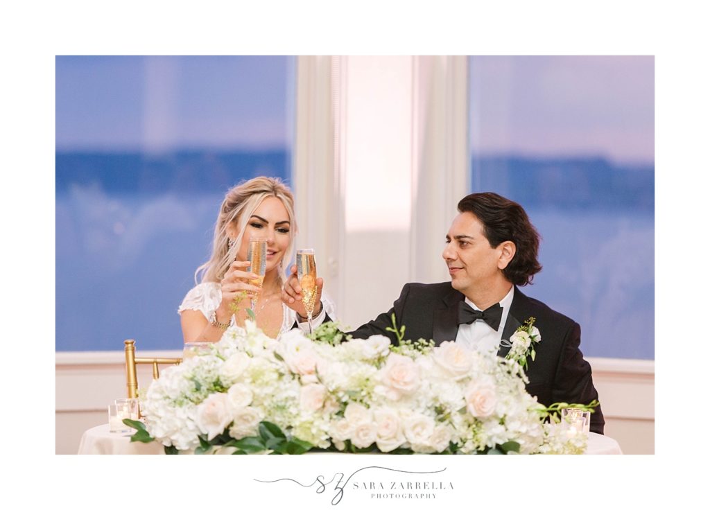 bride and groom toast during wedding reception photographed by Sara Zarrella Photography