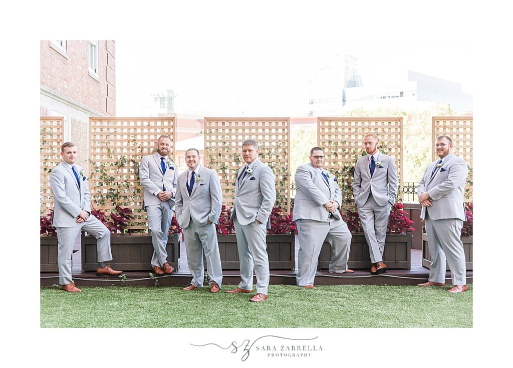 groomsmen pose on rooftop at Providence G with Sara Zarrella Photography