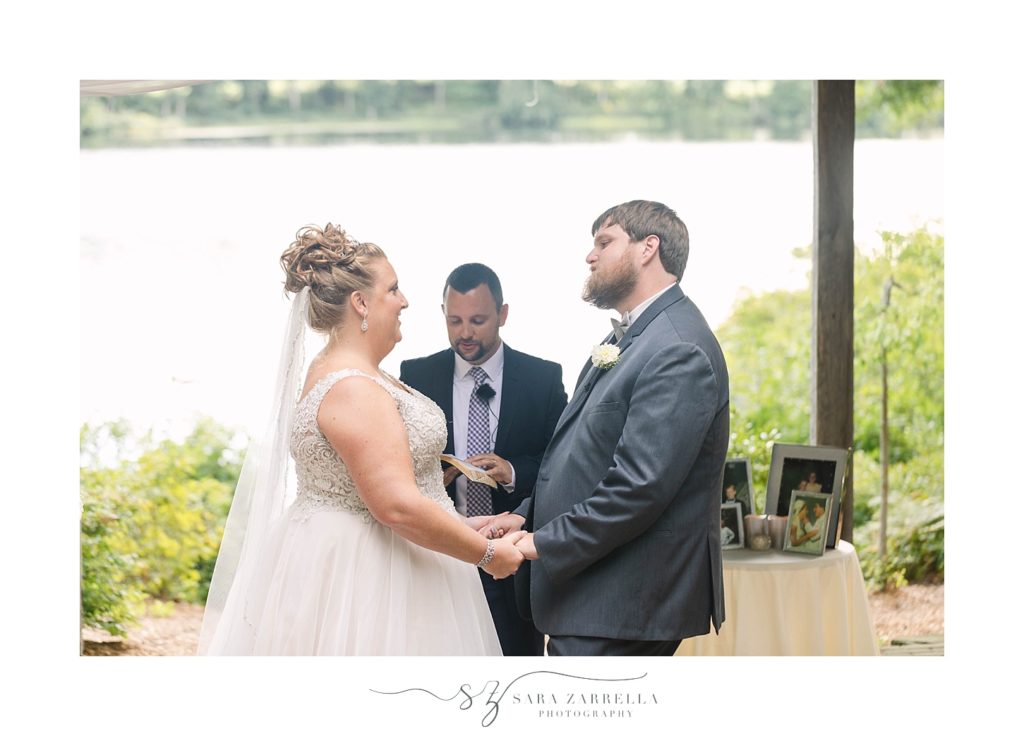 couple exchanges vows in front of lake photographed by Sara Zarrella Photography