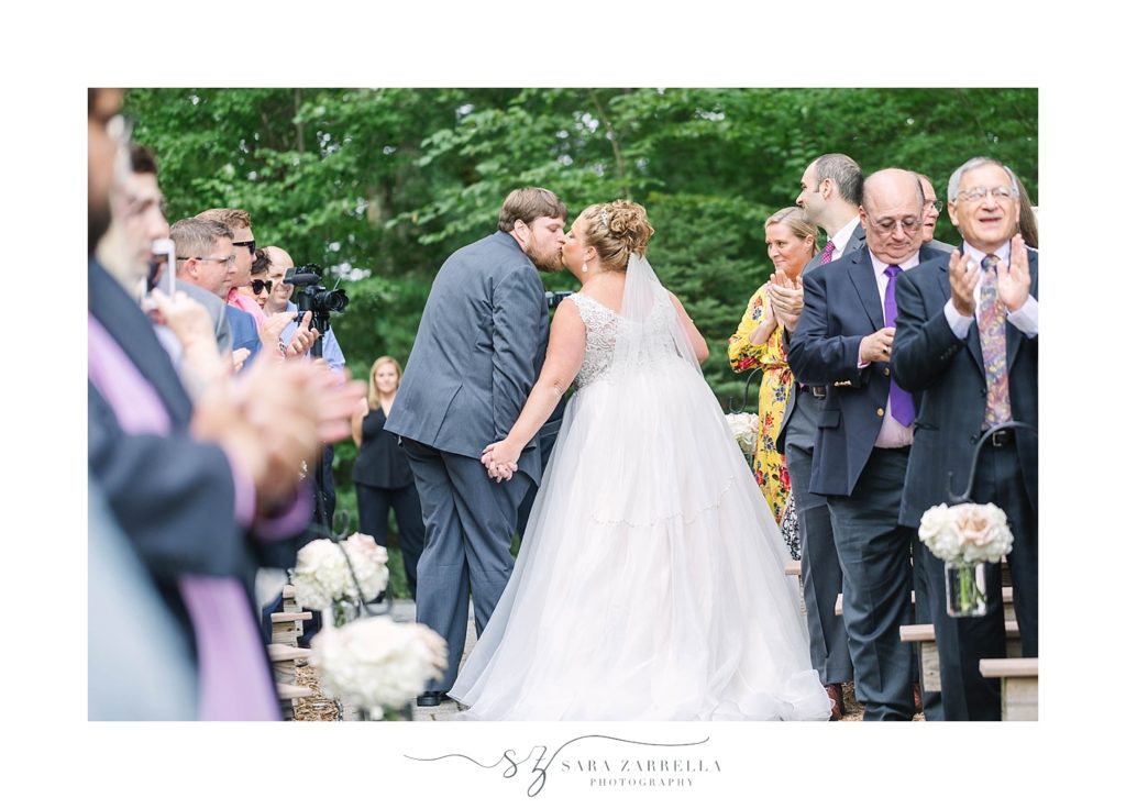 bride and groom kiss at ceremony with Sara Zarrella Photography