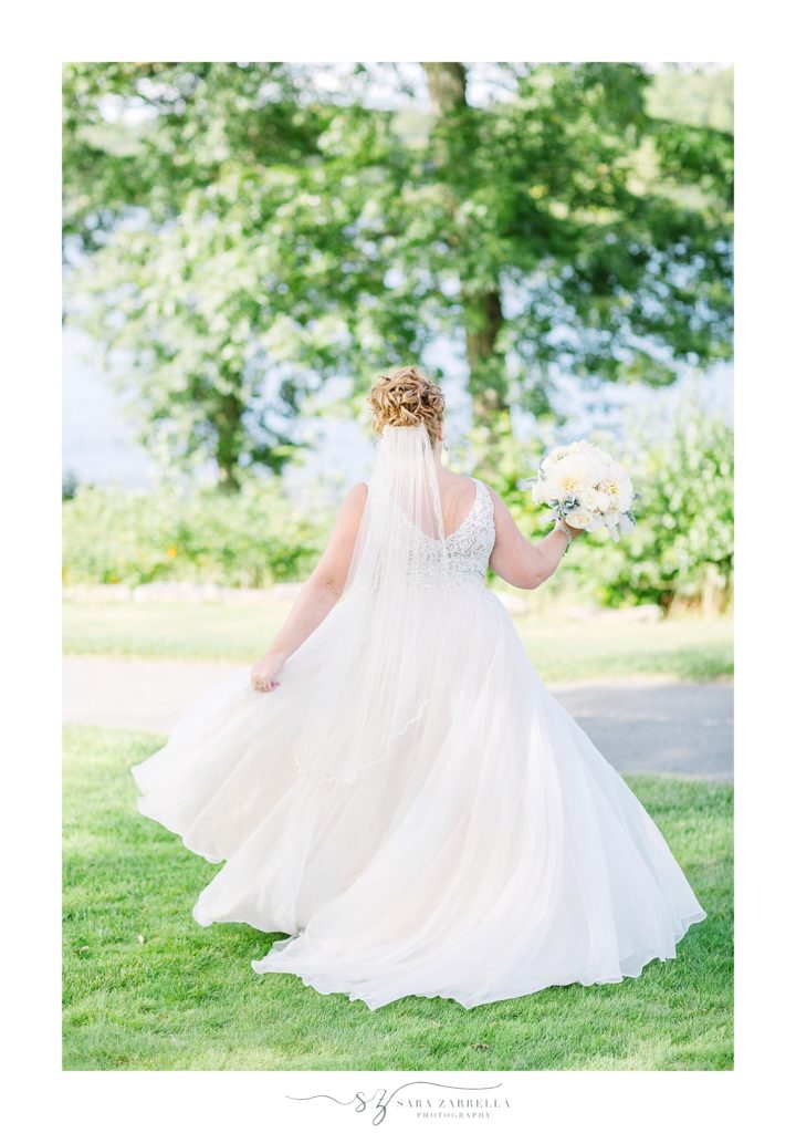 bride twirls in Essense of Australia gown photographed by Sara Zarrella Photography