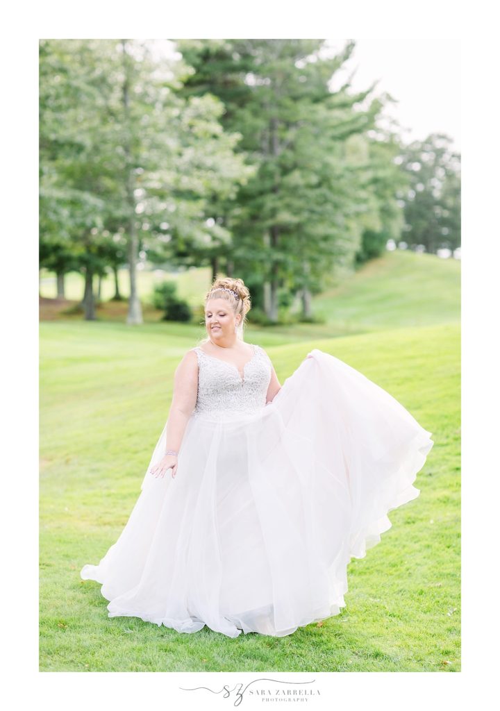 bride twirls in wedding gown photographed by Sara Zarrella Photography
