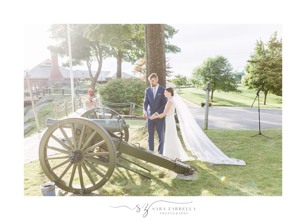 bride and groom load cannon on wedding day with Sara Zarrella Photography