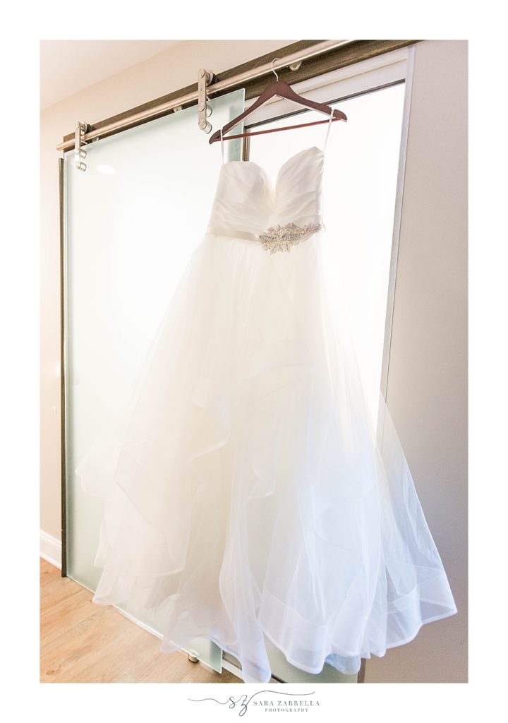 bride's dress hangs in Wydham Newport photographed by Sara Zarrella Photography