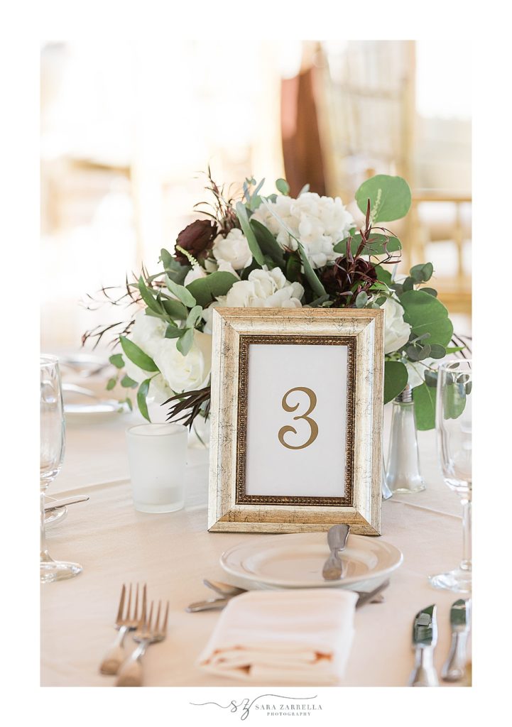 gold and ivory centerpieces for Regatta Place wedding reception with Sara Zarrella Photography