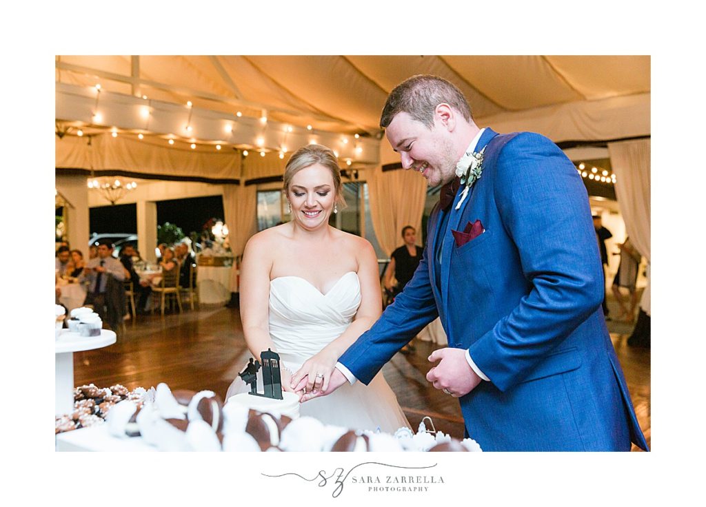 bride and groom cut cake photographed by Sara Zarrella Photography