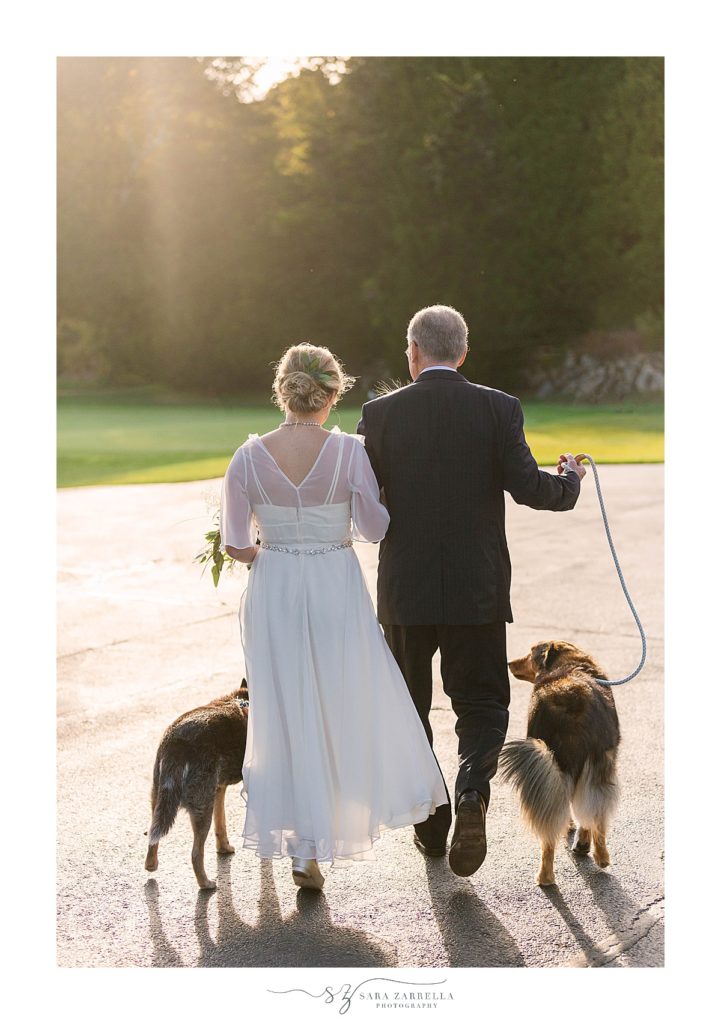 bride walks down the aisle with father and dogs at Weekapaug Golf Club