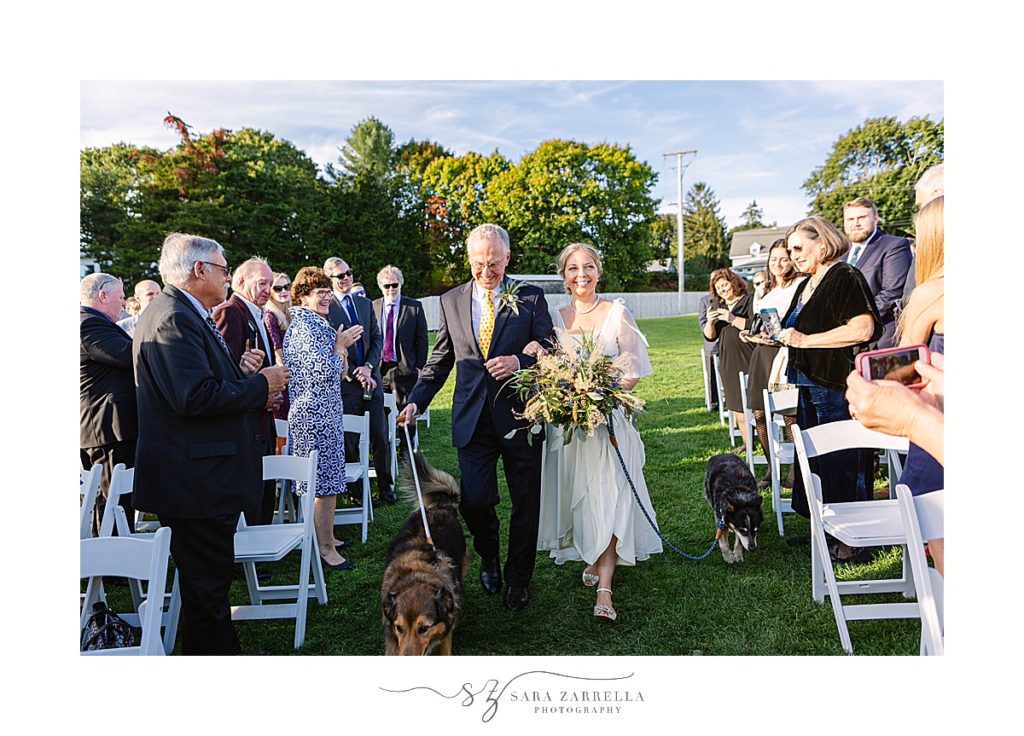bride walks down aisle at Weekapaug Golf Club wedding photographed by Sara Zarrella Photography