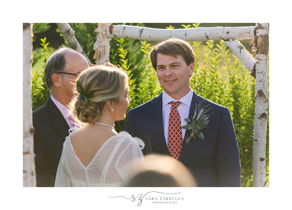 groom admires bride at Weekapaug Golf Club wedding ceremony photographed by Sara Zarrella Photography
