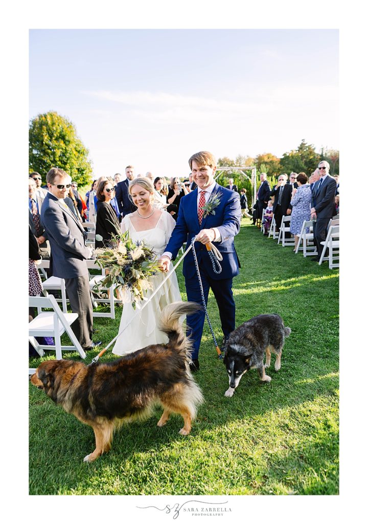 wedding ceremony exit with bride, groom, and their dogs photographed by Sara Zarrella Photography