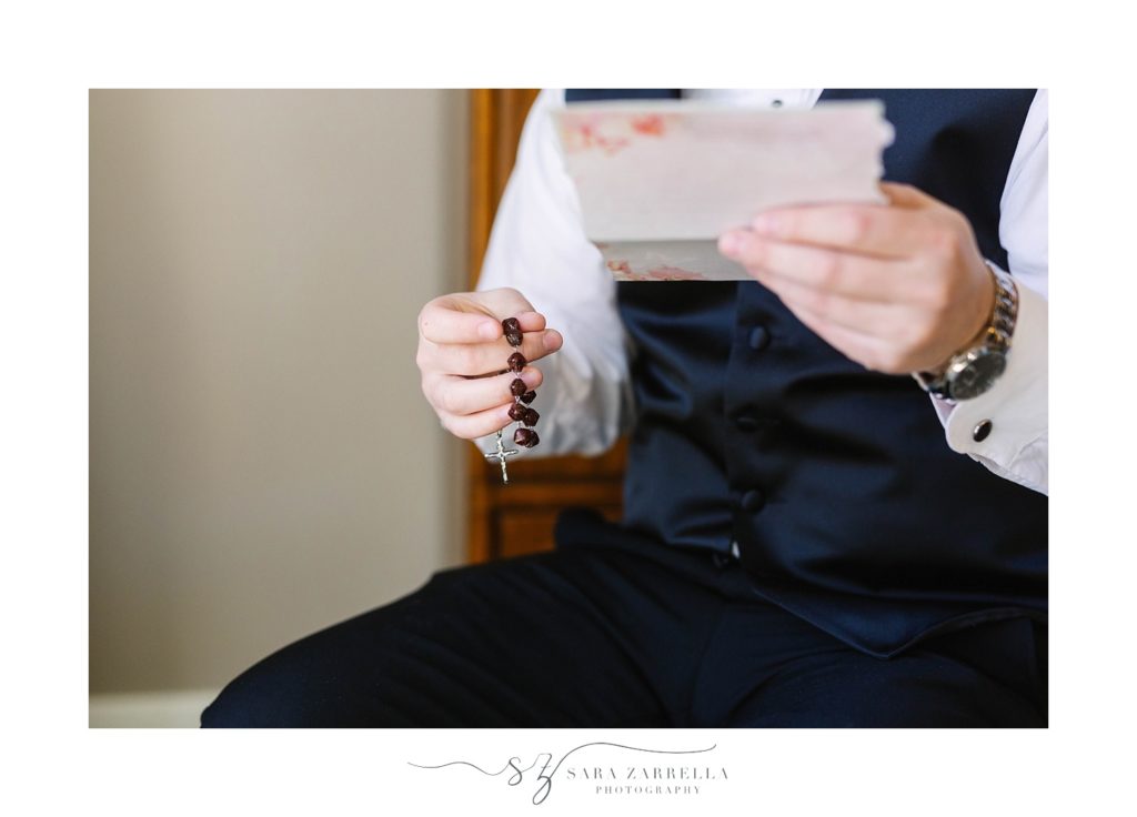 groom opens gift from bride on wedding day with Sara Zarrella Photography