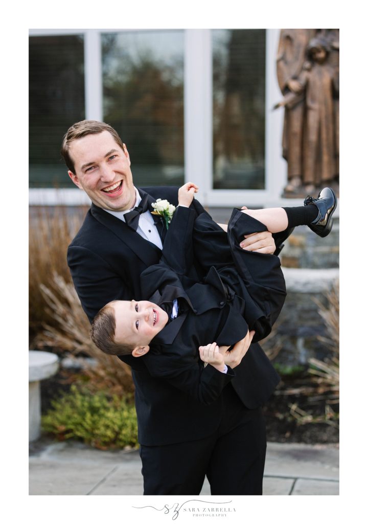groom and ring bearer play before wedding ceremony photographed by Sara Zarrella Photography