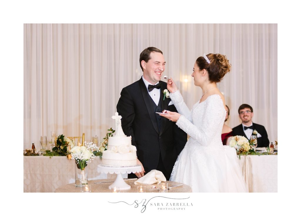 bride and groom cut wedding cake from Leddy's photographed by Sara Zarrella Photography