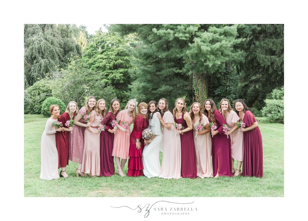 bridesmaids in red and pink pose for MA wedding photographer Sara Zarrella Photography