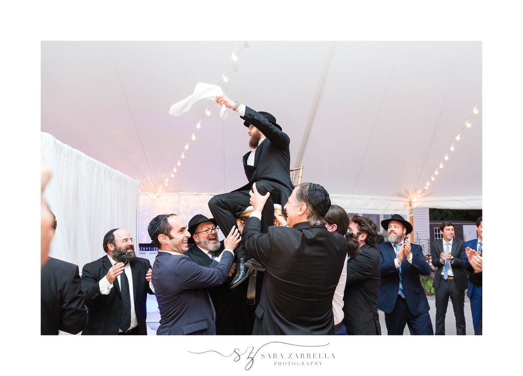traditional chair dance at Jewish wedding photographed by Sara Zarrella Photography