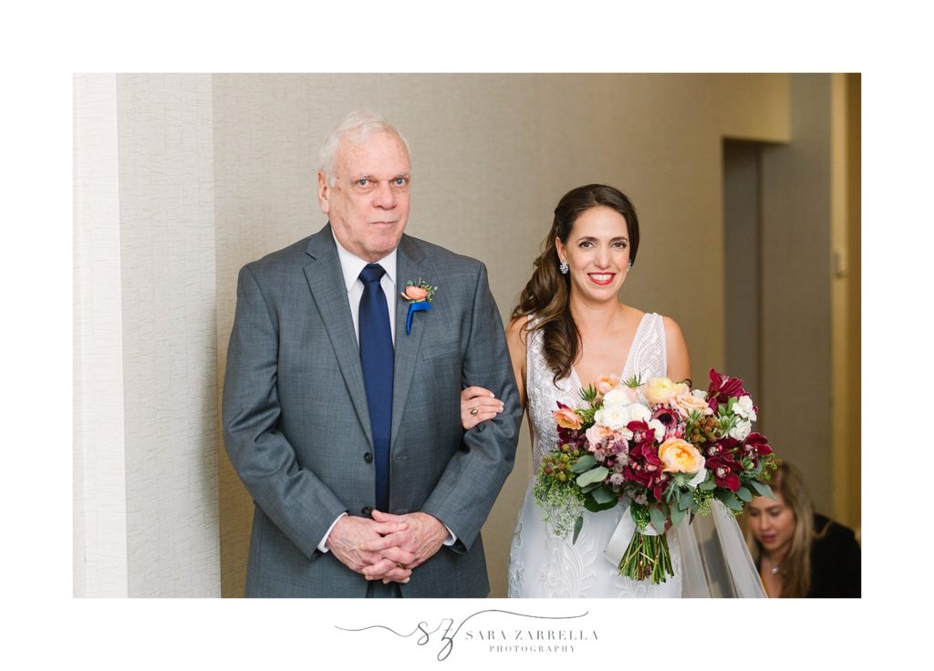 groom and father walk down aisle at Gurney's photographed by Sara Zarrella Photography