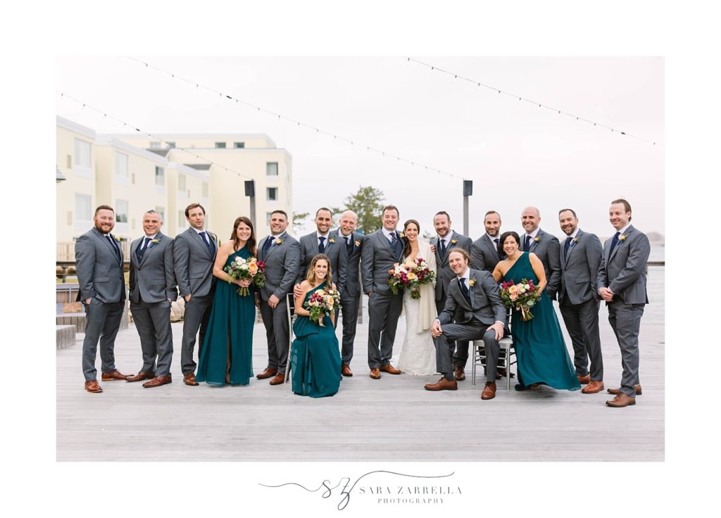 bridesmaids in teal and groomsmen in grey suits for RI wedding pose for Sara Zarrella Photography