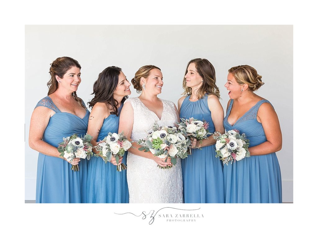 bridesmaids in pale blue gowns pose for RI wedding photographer Sara Zarrella Photography