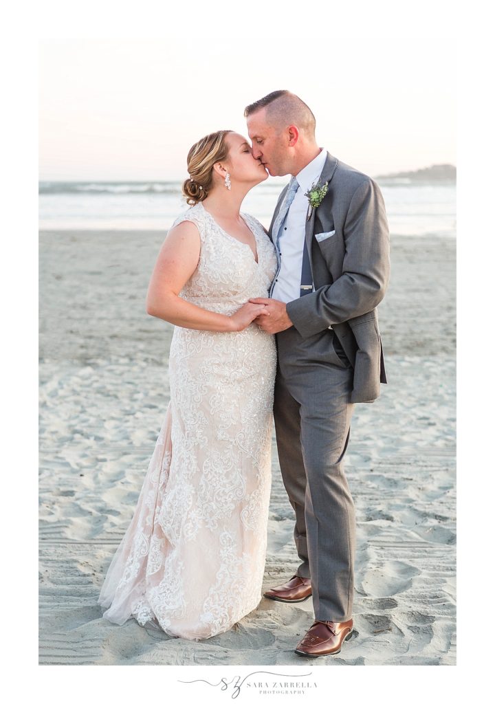bride and groom kiss on Newport RI beach photographed by Sara Zarrella Photography