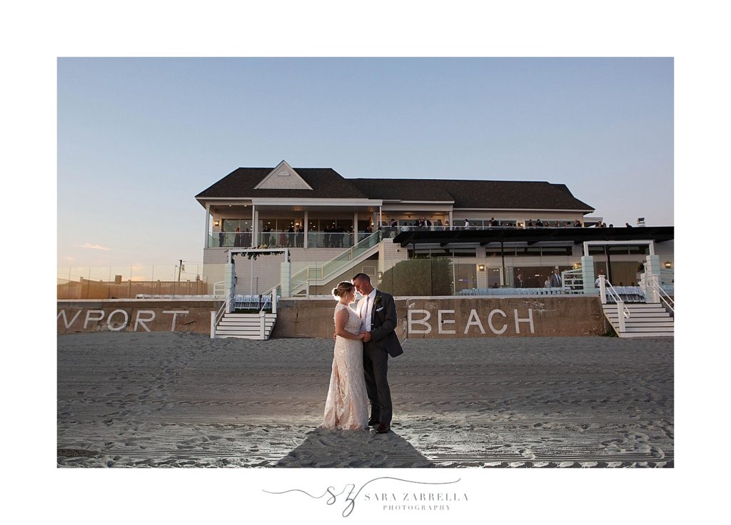 newlyweds pose in front of Newport Beach House for Sara Zarrella Photography