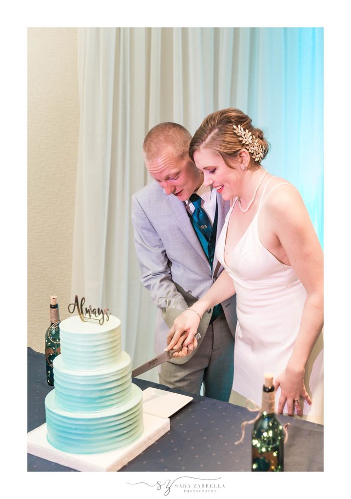 bride and groom cut wedding cake at Newport Marriott