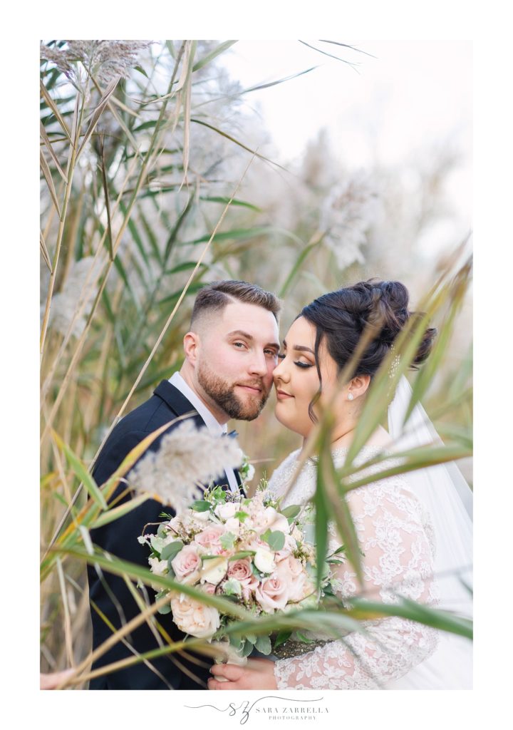 bride and groom snuggle in the garden photographed by Sara Zarrella Photography