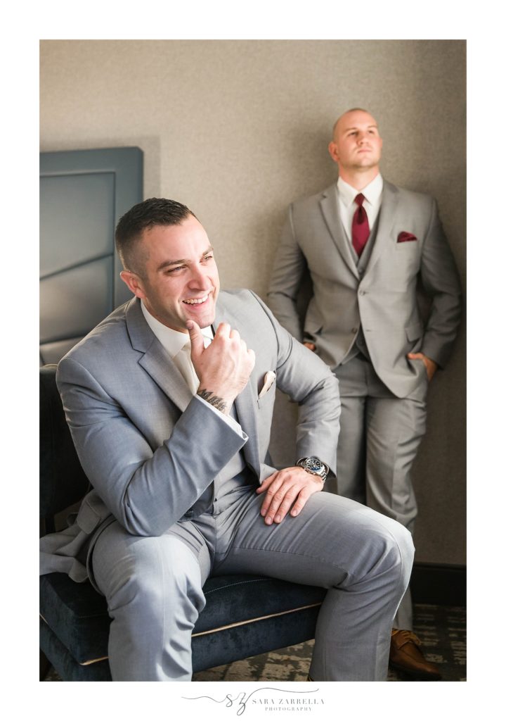 groom poses for silly portrait on wedding day with Sara Zarrella Photography