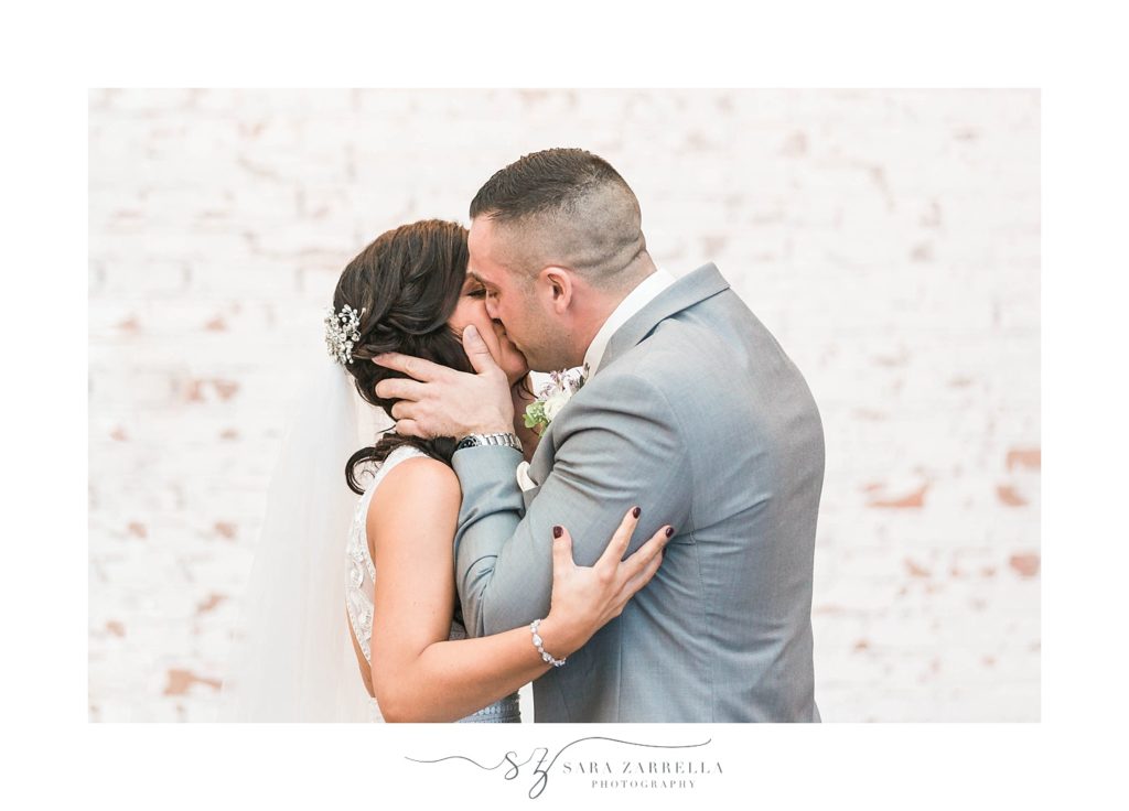 bride and groom's first kiss on wedding day in Rhode Island photographed by Sara Zarrella Photography
