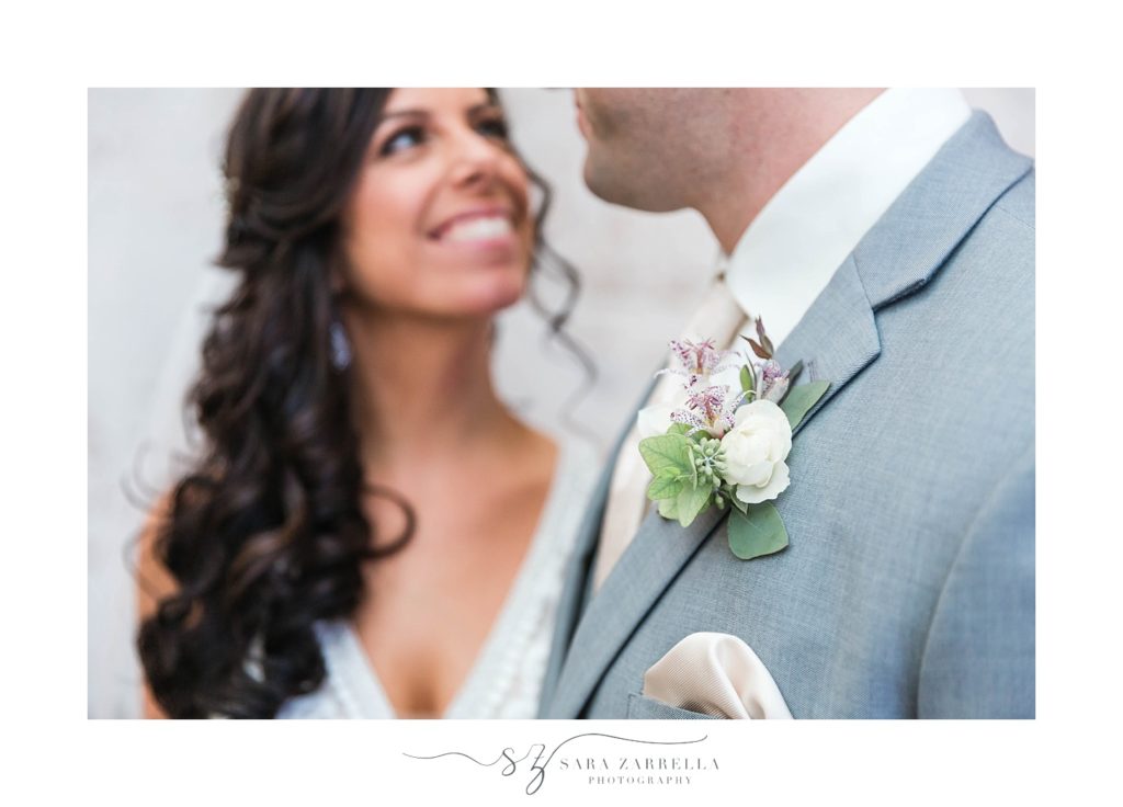 bride and groom smile during first look photographed by Sara Zarrella Photography