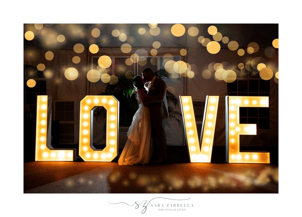 nighttime wedding portrait by LOVE sign with Sara Zarrella Photography