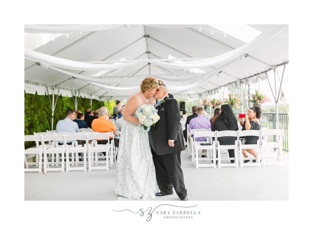 couple kisses at end of aisle at Kirkbrae Country Club
